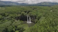 Aerial View Of A Waterfall Amidst A Green Hawaiian Landscape Stock Footage