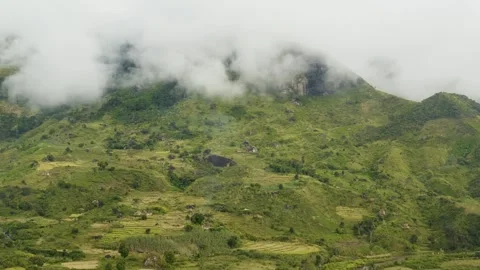 Aerial view of waterfall and green hills, Madagascar. Stock Footage 312338529
