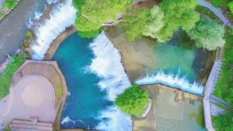Aerial view of waterfall and river surrounded by lush forest in Bosnia and Stock Footage 324711531