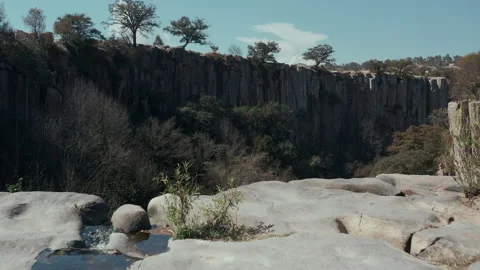 Aerial view waterfall with black columns on the sides of canyon  Stock Footage 172504352