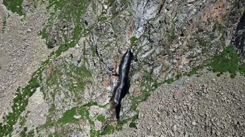 Aerial view of a waterfall cascading down a rocky mountain. Nature landscape Stock Footage 327631523