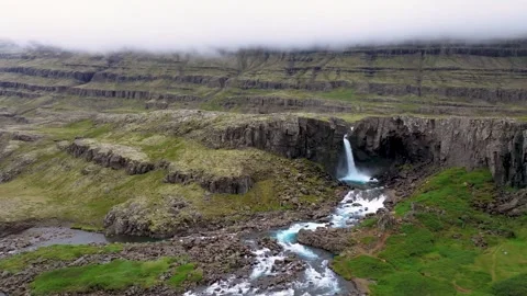 Aerial view of waterfall cascading into valley, Iceland. Stock Footage 288466393