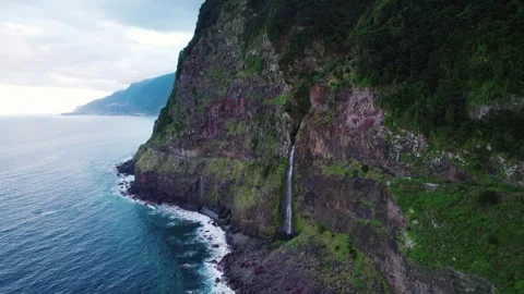 Aerial view of a waterfall falling into the Atlantic ocean in north Made Video stock 329068434