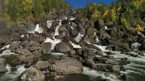 Aerial view of waterfall, flying over autumn forest, waterfall with big stones Video stock 81316971
