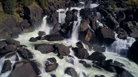 Aerial view of waterfall, flying over autumn forest, waterfall with big stones Stock Footage 84467485