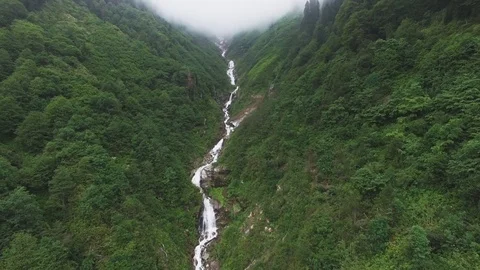 Aerial view of the waterfall getting trough the clouds Stock Footage 97547254