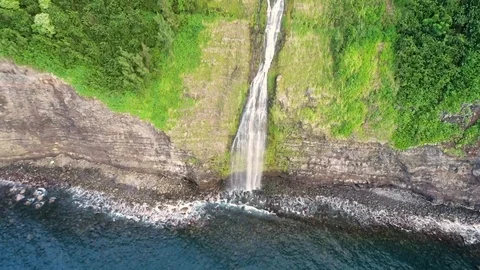 Aerial view of waterfall hitting the ocean water, Hawaii, U.S.A. Stock Footage 102140096