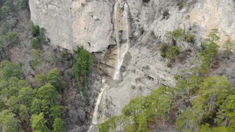 Aerial view of waterfall. Mountain river flows down from top of gray rocks Stock Footage 157539009