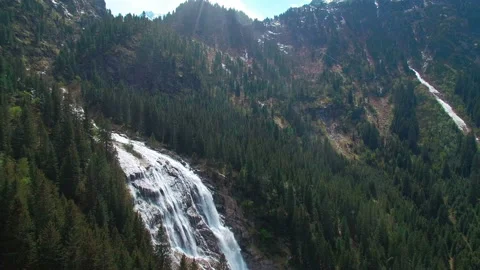 Aerial view of a waterfall on the pine forests in the mountains in Austria. Stock Footage 87331951