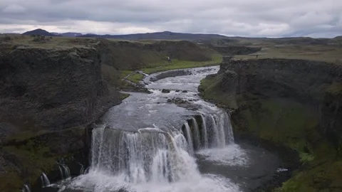 Aerial view of waterfall in rugged volcanic landscape, Iceland. Stock Footage 337460132