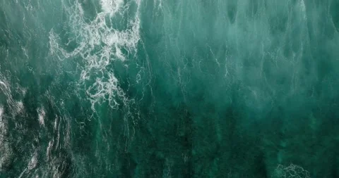 Aerial view of a wave crashing on winter beach covered in snow Stock Footage 270559196
