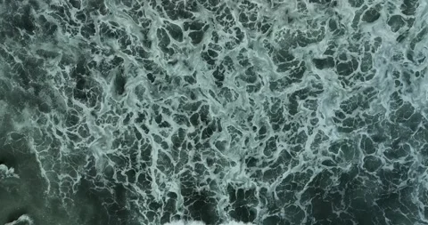 Aerial view of a wave crashing on winter beach covered in snow Stock Footage 281261681