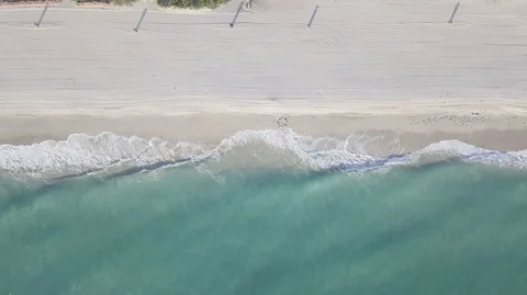 AERIAL VIEW OF WAVES AGAINST WHITE SAND BEACH Stock Footage 104482228