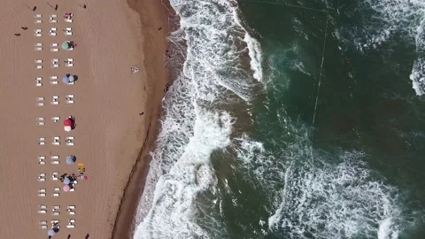 Aerial view of waves and sunbeds in the morning. Stock Footage 144591773