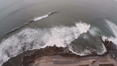 Aerial view of waves Atlantic Ocean rushing to a black pebble shore of Tenerife. Stock Footage 155052489
