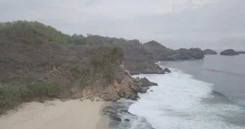 Aerial view of the waves on the beach, and fly through coral along with black Stock Footage 121637725