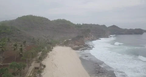 Aerial view of the waves on the beach, and fly through coral, raw footage, un Stock Footage 121647423
