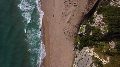 Aerial view of waves at beach and mountains Stock Footage 144592115
