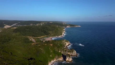 Aerial view of waves at beach and mountains Stock Footage 144592157