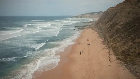 Aerial view of waves on a beautiful sandy ocean beach and cliff Stock Footage 134835355