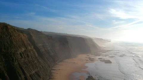 Aerial view of waves on a beautiful sandy ocean beach and cliff Stock Footage 143733065