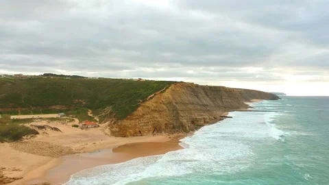 Aerial view of waves on a beautiful sandy ocean beach and cliff. Stock Footage 146282316