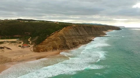 Aerial view of waves on a beautiful sandy ocean beach and cliff. Stock Footage 146282900