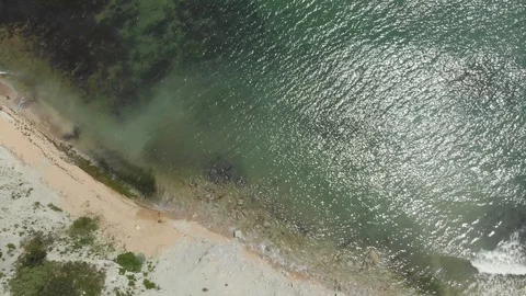 Aerial view waves break against the rocks on the beach in a storm Stock Footage 97183430