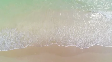Aerial view waves break on sand beach Stock Footage 85662506