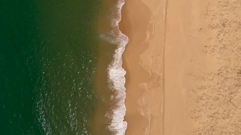 Aerial View Waves Break On Sand Beach While Tracking Forward Stock Footage 99021014