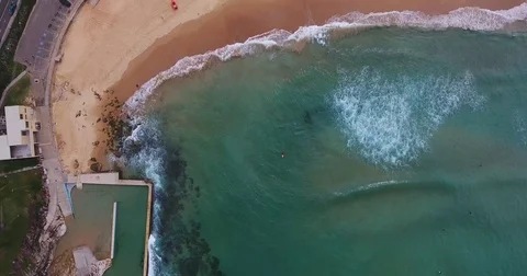 Aerial View Waves Break On White Sand Beach Surfer At Sunset in summer Stock Footage 70826154