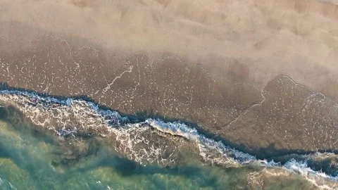 Aerial view waves break on white sand beach Stock Footage 84813548