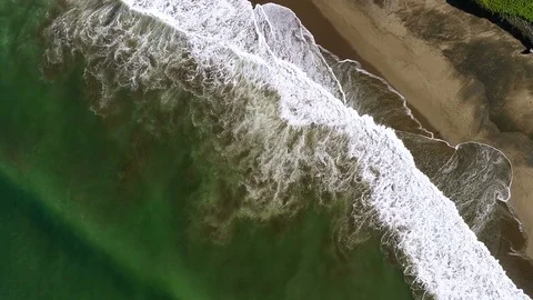 Aerial view waves break on white sand beach Stock Footage 84813848