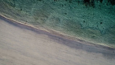 Aerial view waves break on white sand beach Stock Footage 84841357