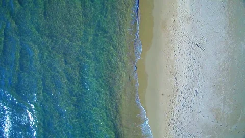 Aerial view waves break on white sand beach Stock Footage 85212054