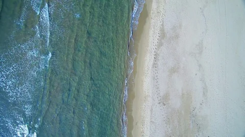 Aerial view waves break on white sand beach Stock Footage 85212061