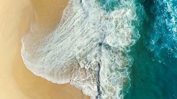 Aerial view waves break on white sand beach. Stock Footage 86141197