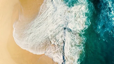 Aerial view waves break on white sand beach Video stock 86498980