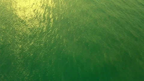 Aerial view waves break on white sand beach at sunset. Sea waves on the Stock Footage 90276640