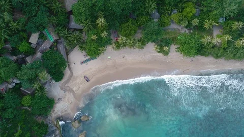 Aerial view waves break on white sand beach at sunset Stock Footage 92965824