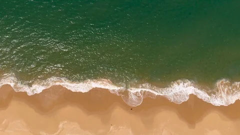 Aerial View Waves Break On White Sand Beach Then Tilt Up To Sky Stock Footage 99021027