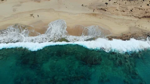 Aerial view waves break on white sand beach. 스톡 동영상 104728748