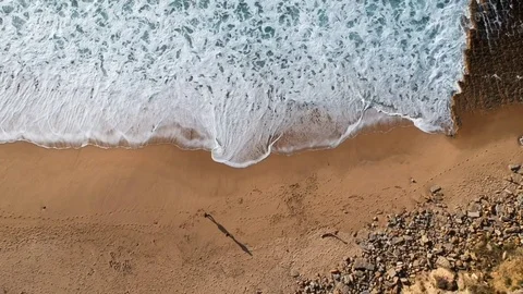 Aerial view waves break on white sand beach Stock Footage 105914362