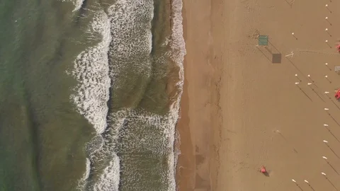 Aerial view waves break on white sand beach. Stock Footage 114193834