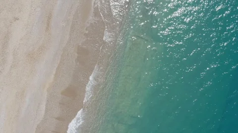 Aerial view waves break on white sand beach. Sea waves on the beautiful beach Stock Footage 114310821