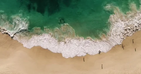 Aerial view waves break on white sand beach. Stock Footage 250596623