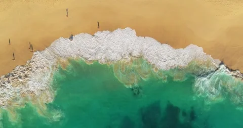 Aerial view waves break on white sand beach. Sea waves on the beautiful beach. 動画素材 251785119