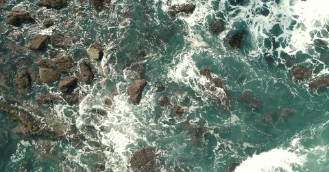 Aerial view of waves breaking against rocks Stock Footage 80735217