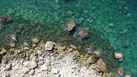 Aerial view of waves breaking against coastline rocks Stock Footage 83368427