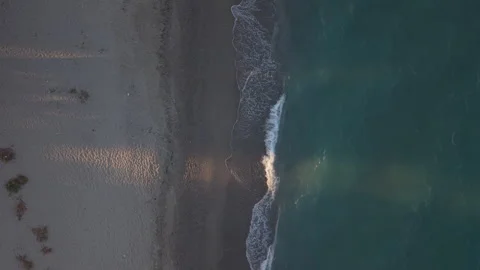 Aerial View of Waves Breaking Along Skotina Beach at Sunset, Greece Stock Footage 345846454